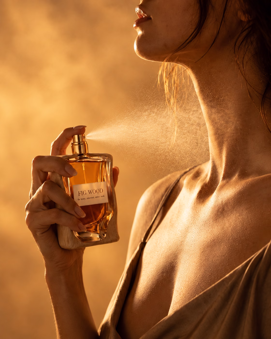 A woman spraying Velmora perfume, golden light